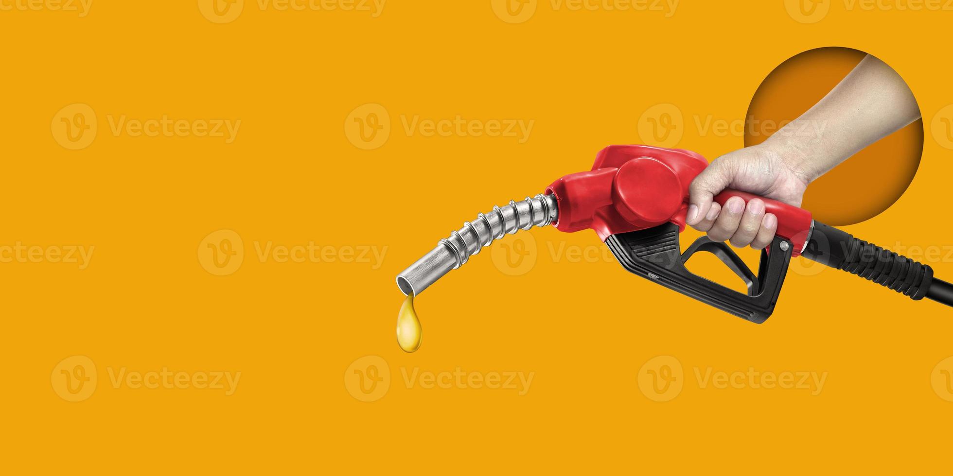 Man holding refueling nozzle on yellow background photo