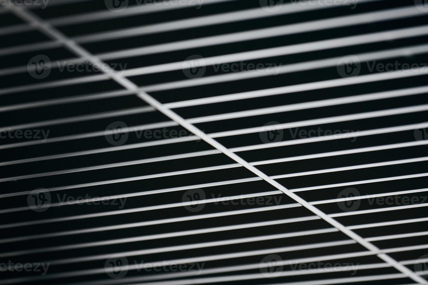 Office grille ceiling. Modern black metal grille ceiling, suspended covering. Abstract design texture. photo
