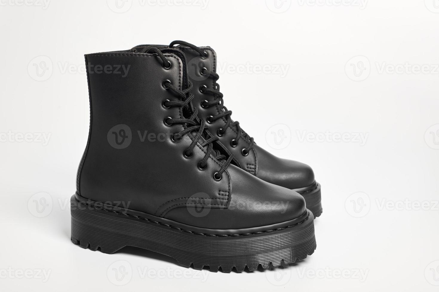 Black women combat boots on high heel platform with lug soles on isolated white background photo