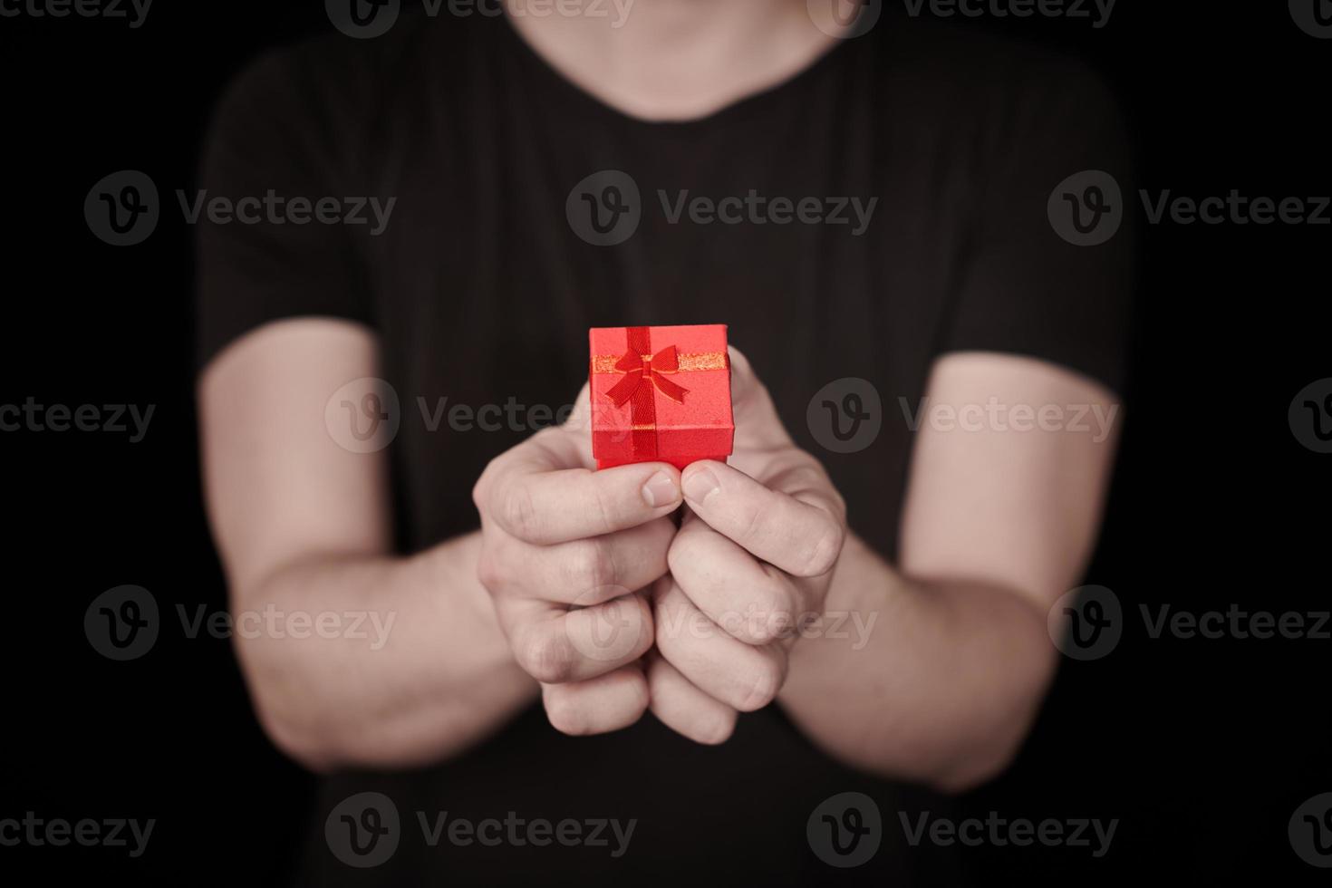 Red gift box in hand on St. Valentine day photo