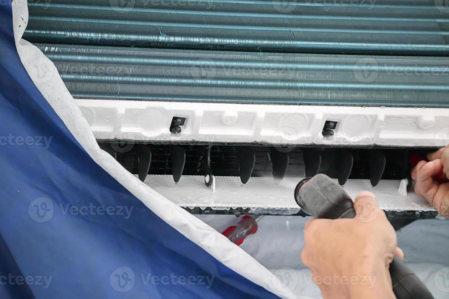 air conditioning cleaning service with water spray photo