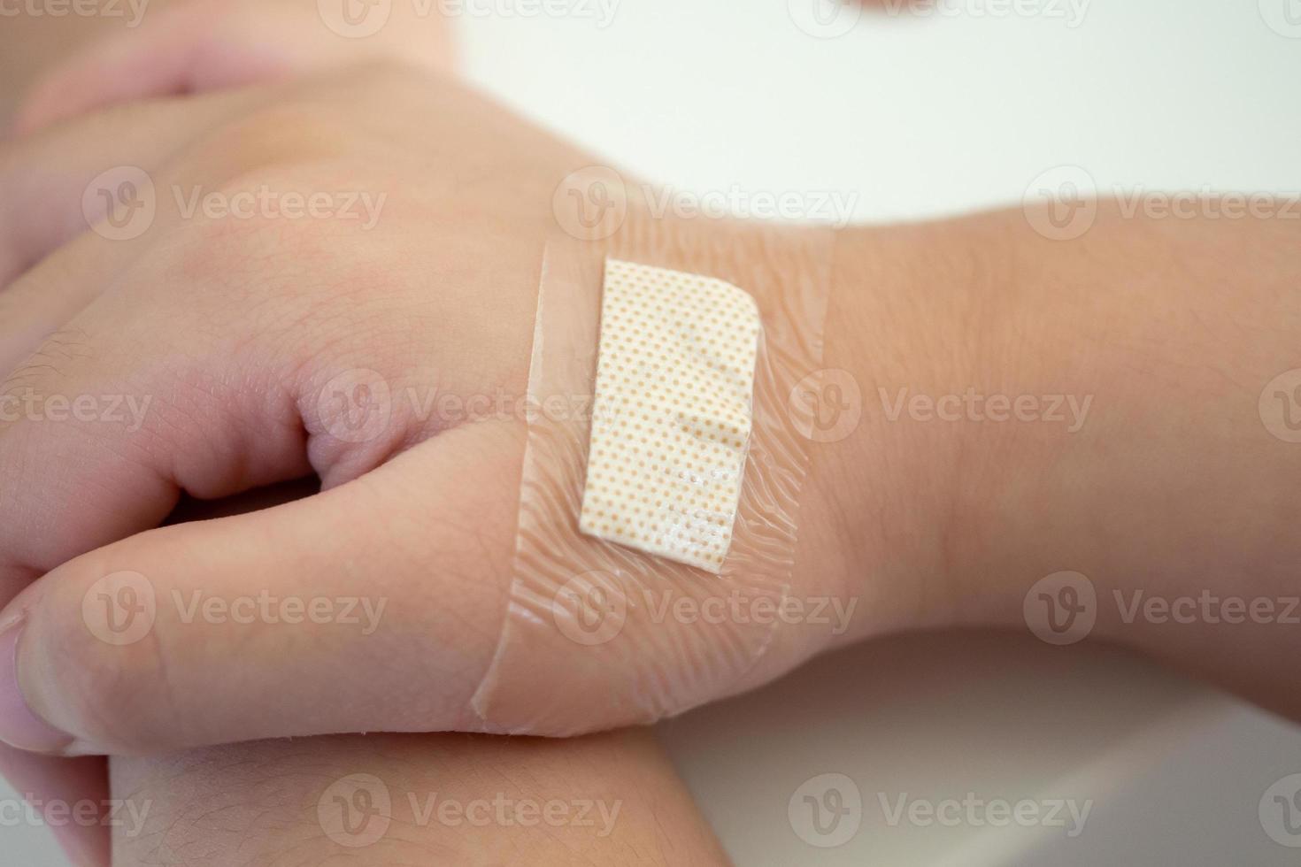 waterproof adhesive plaster on little kid hand photo