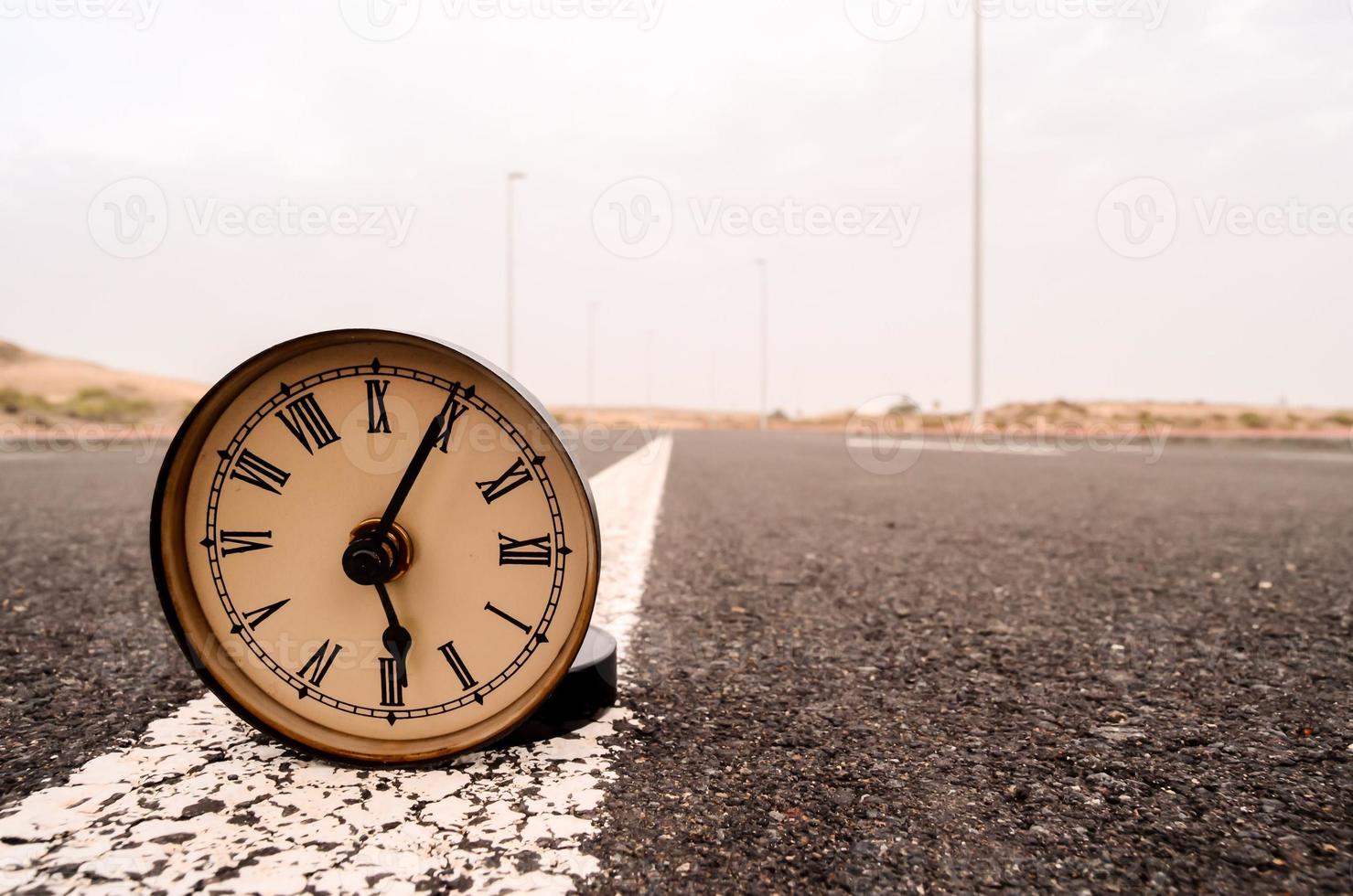 Clock on the road photo