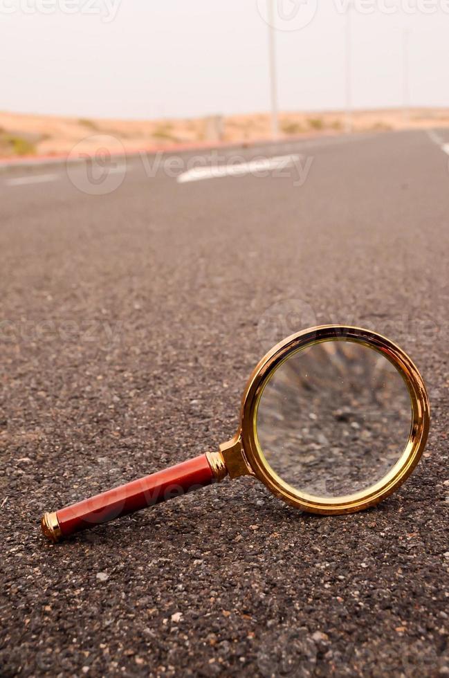 Magnifying glass on the road photo