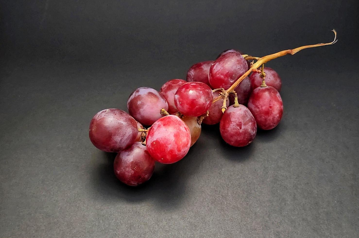 Fresh grapes just picked from the vineyard, isolated om black background. photo