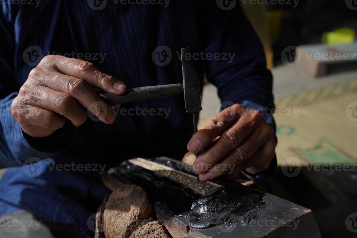 The process of making a keris is being carved to make traditional ornaments photo