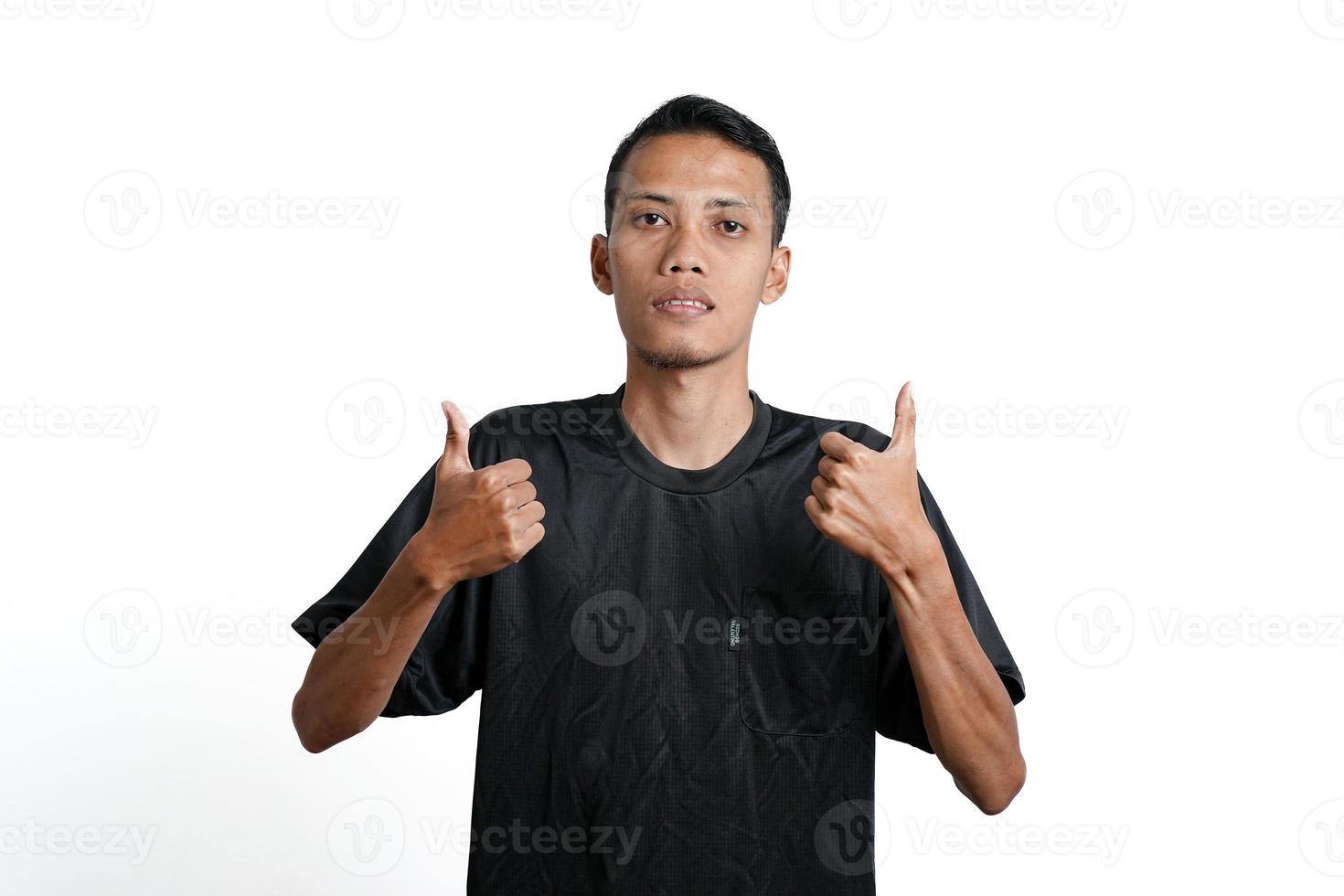 asian man wearing black training t-shirt, feeling happy and giving thumbs up. Isolated by white background photo