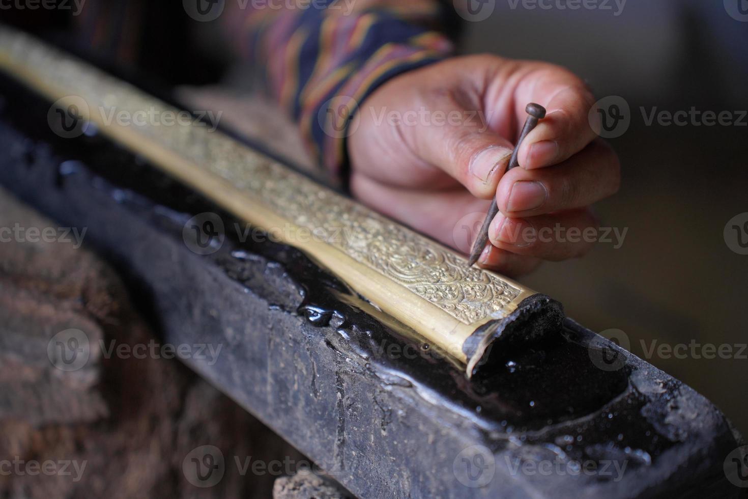 The process of making a keris is being carved to make traditional ornaments photo