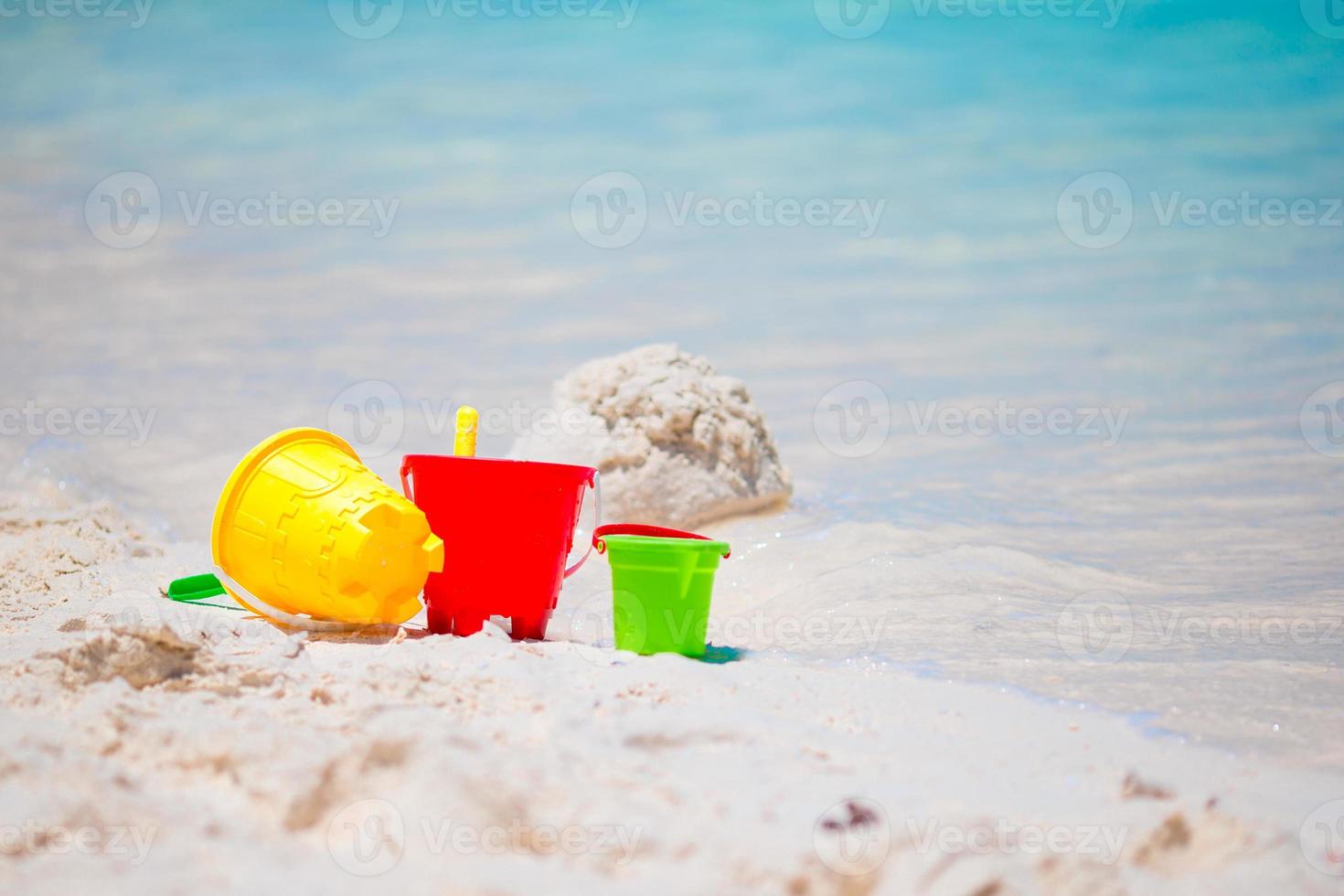 Kid's beach toys on white sandy beach photo