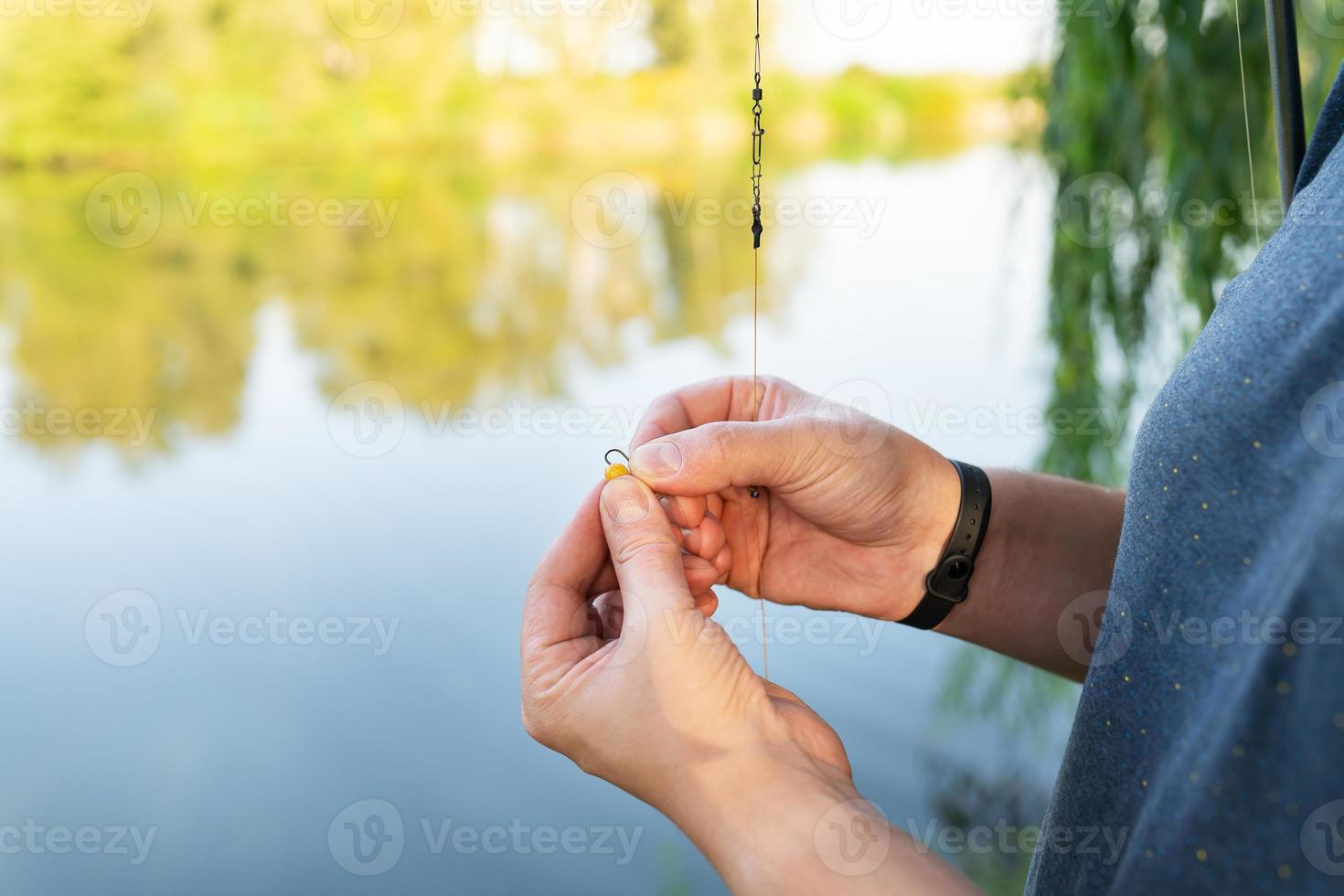 The concept of bait for fish. Close-up of a fisherman's male hand