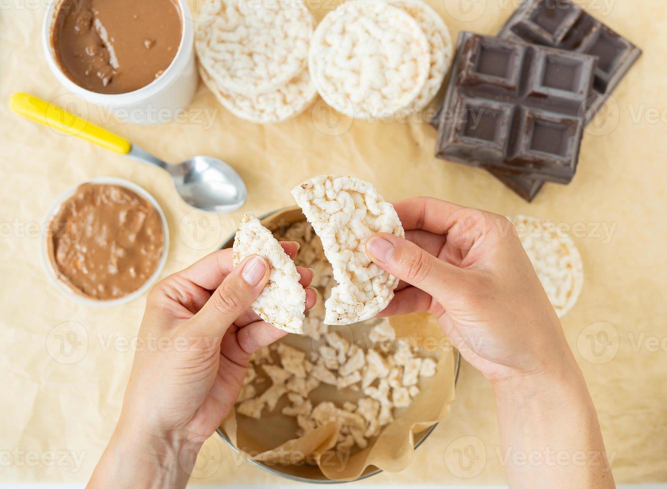 Top view of the process of preparing a delicious dessert peanut butter along with rice cakes. Vegan dessert, tasty and healthy. photo