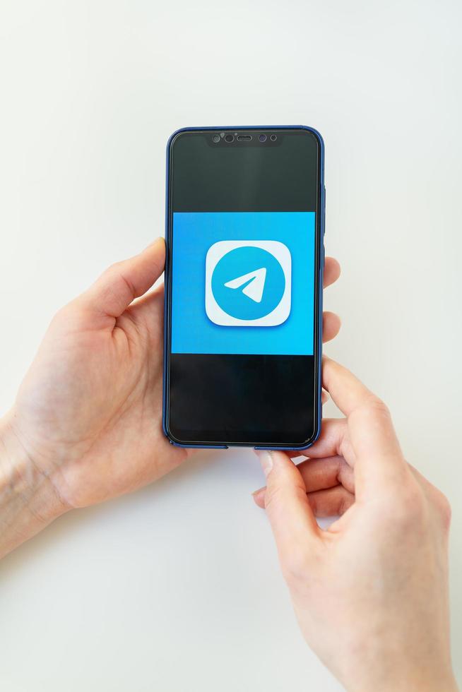 Rivne, Ukraine - December 13, 2022 Telegram mobile application icon on iPhone smartphone screen macro. Telegram is a cross-platform messenger. photo