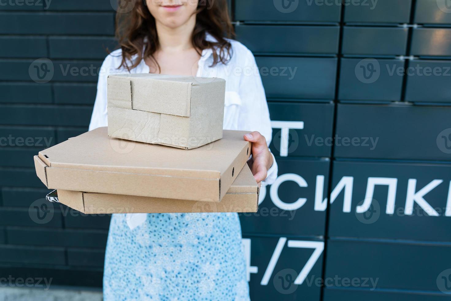 Happy woman holding many different cardboard boxes with online order, satisfied with fast delivery, buying high quality products. photo