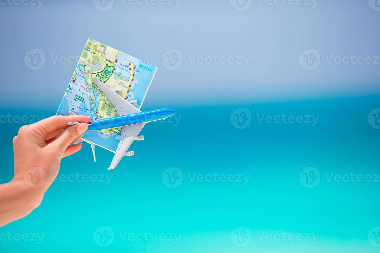Map and toy airplane background the turquoise sea photo