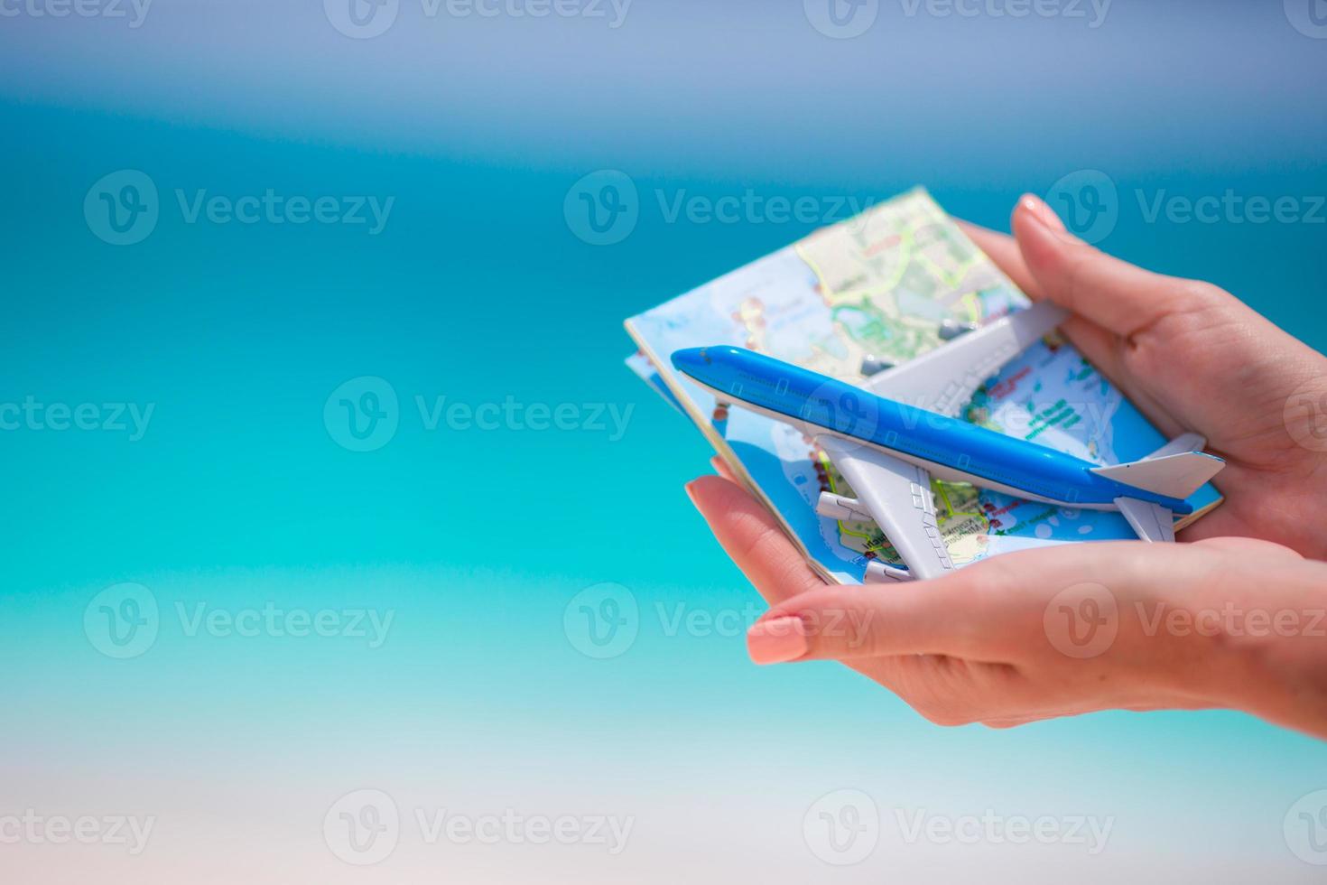 Closeup of map and toy airplane background the sea photo