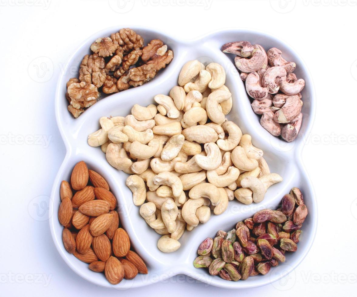 Assorted nuts and dried fruits in oriental style on tray - raisins, almond, dried cranberry. photo