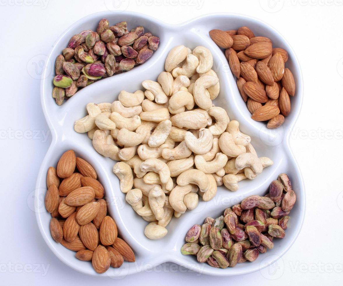 Assorted nuts and dried fruits in oriental style on tray - raisins, almond, dried cranberry. photo