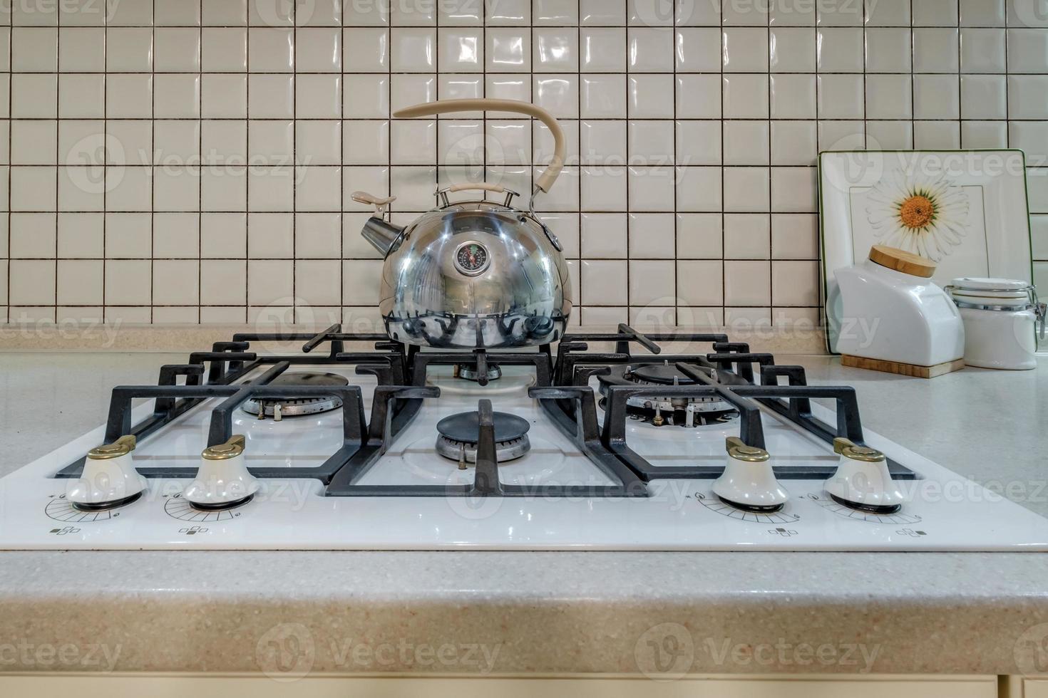 kettle on gas stove in modern kitchen photo