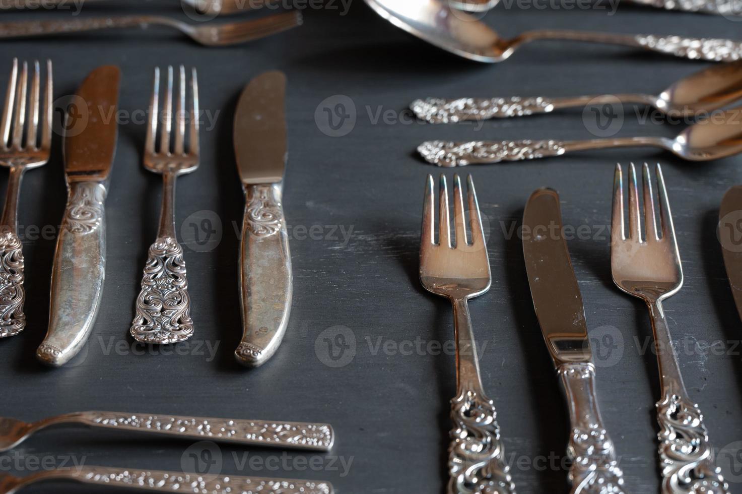 Closeup of a variety of ornate silverware items. photo