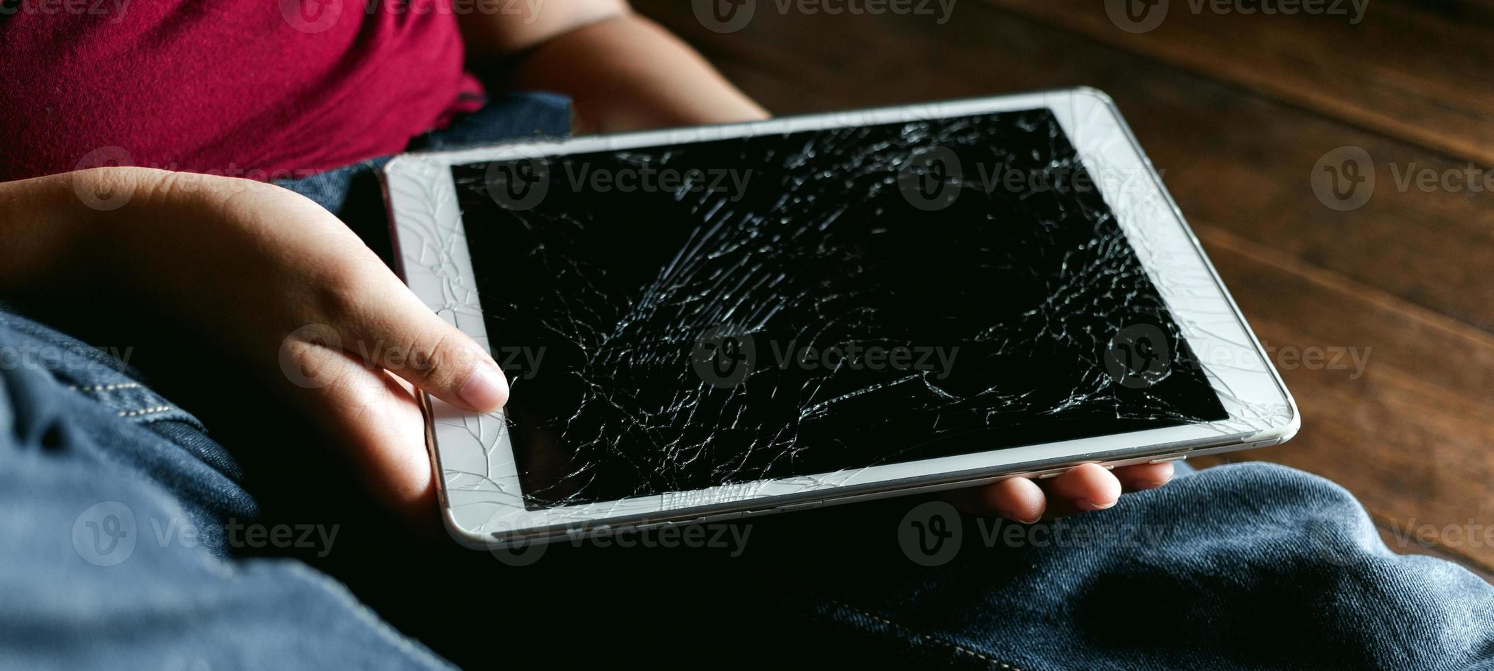 Portrait of a little Asian boy, Kid sad face, Unhappy child sitting holding  broken tablet computer, Emotion sad and sad face, depressed children concept photo