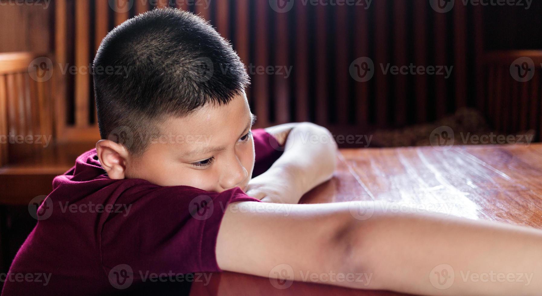 Portrait of a little Asian boy, Kid sad face, Unhappy child looking out, Emotion sad and sad face, depression children concept photo