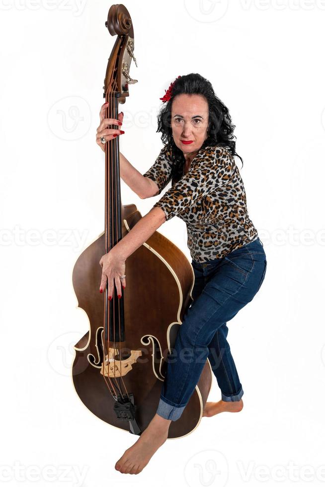 middle aged woman with a double bass on a white background photo