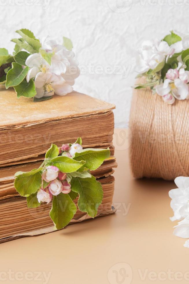 Blossom apple twigs with vinage books. Spring still life composition photo