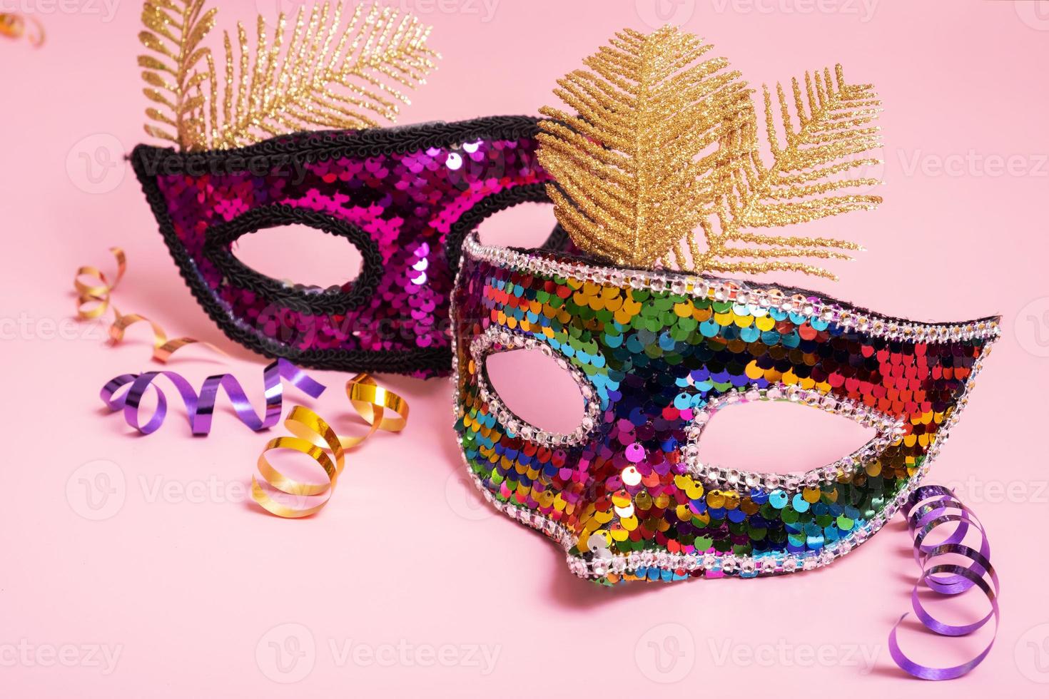 Festive face mask for carnival or masquerade celebration on colored background photo