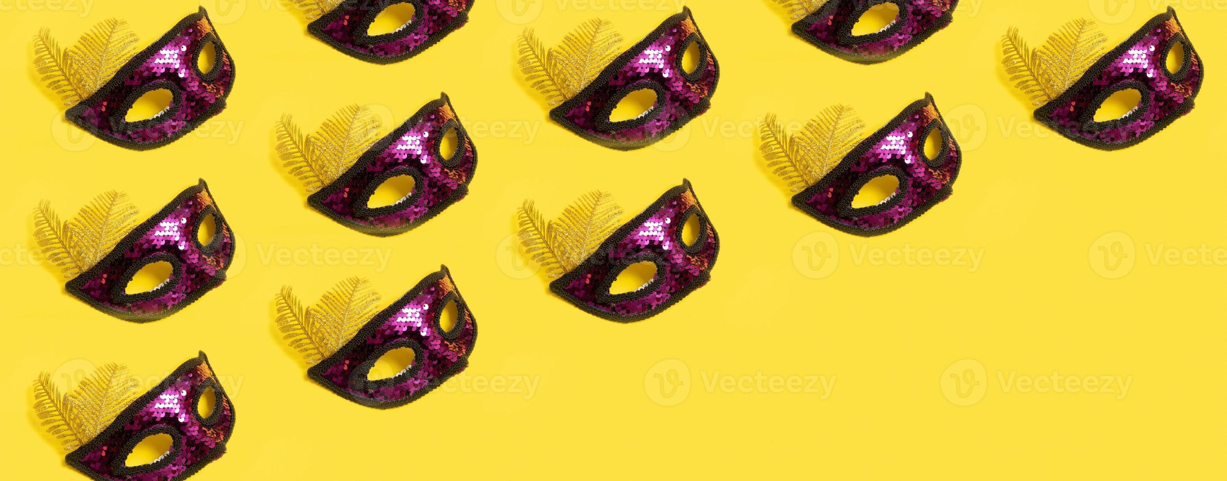 Festive face mask pattern for carnival or masquerade celebration on colored background. Banner format photo