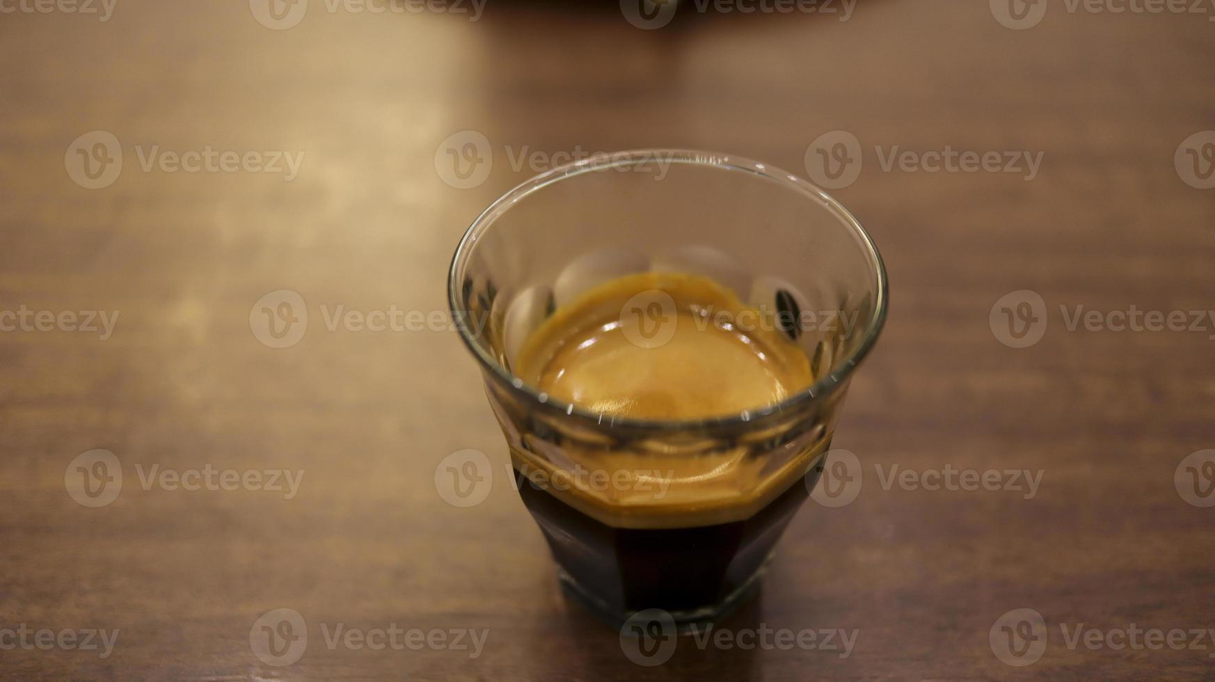 Espresso coffee in a small glass at the table. photo