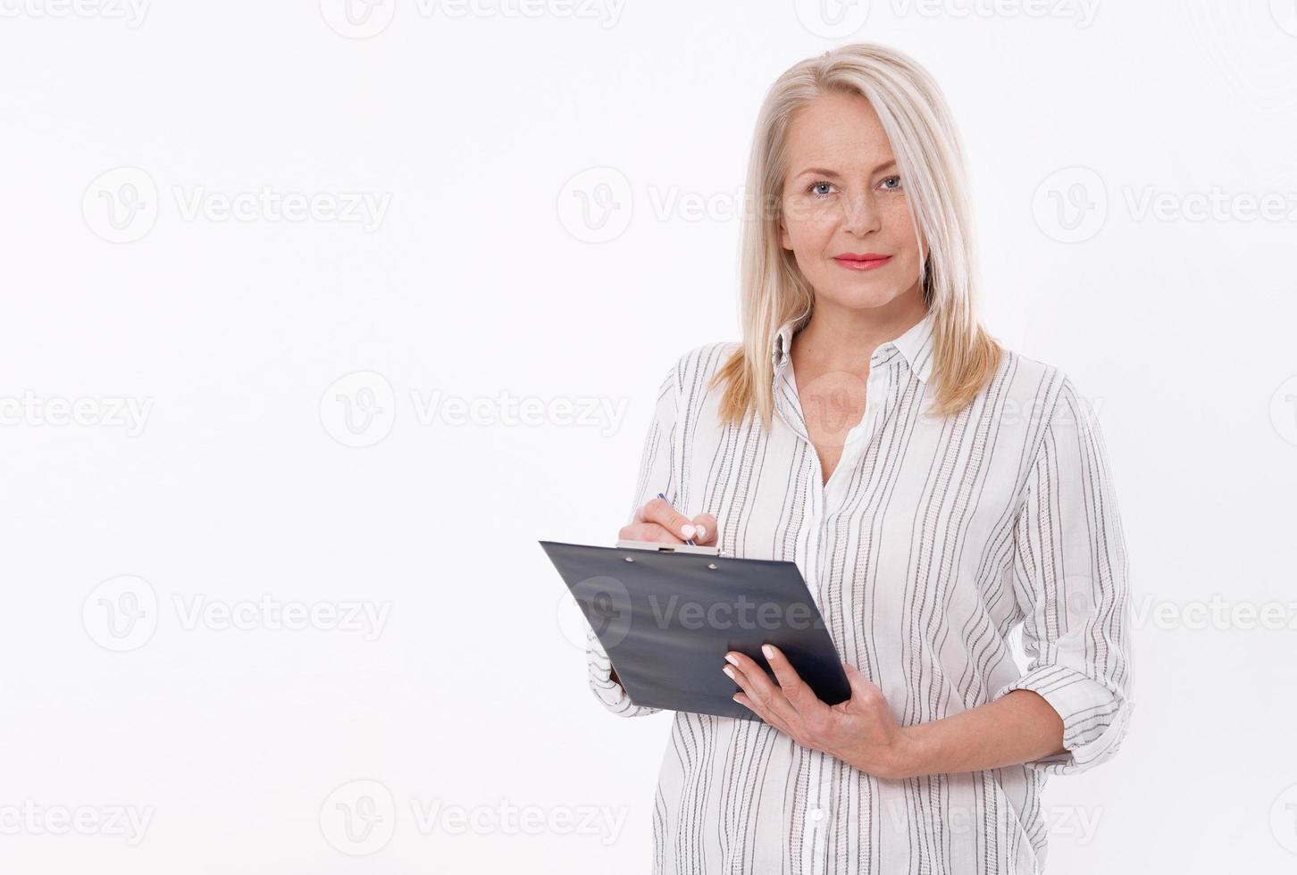 Business woman holds a pen and a folder with files isolated on white background photo