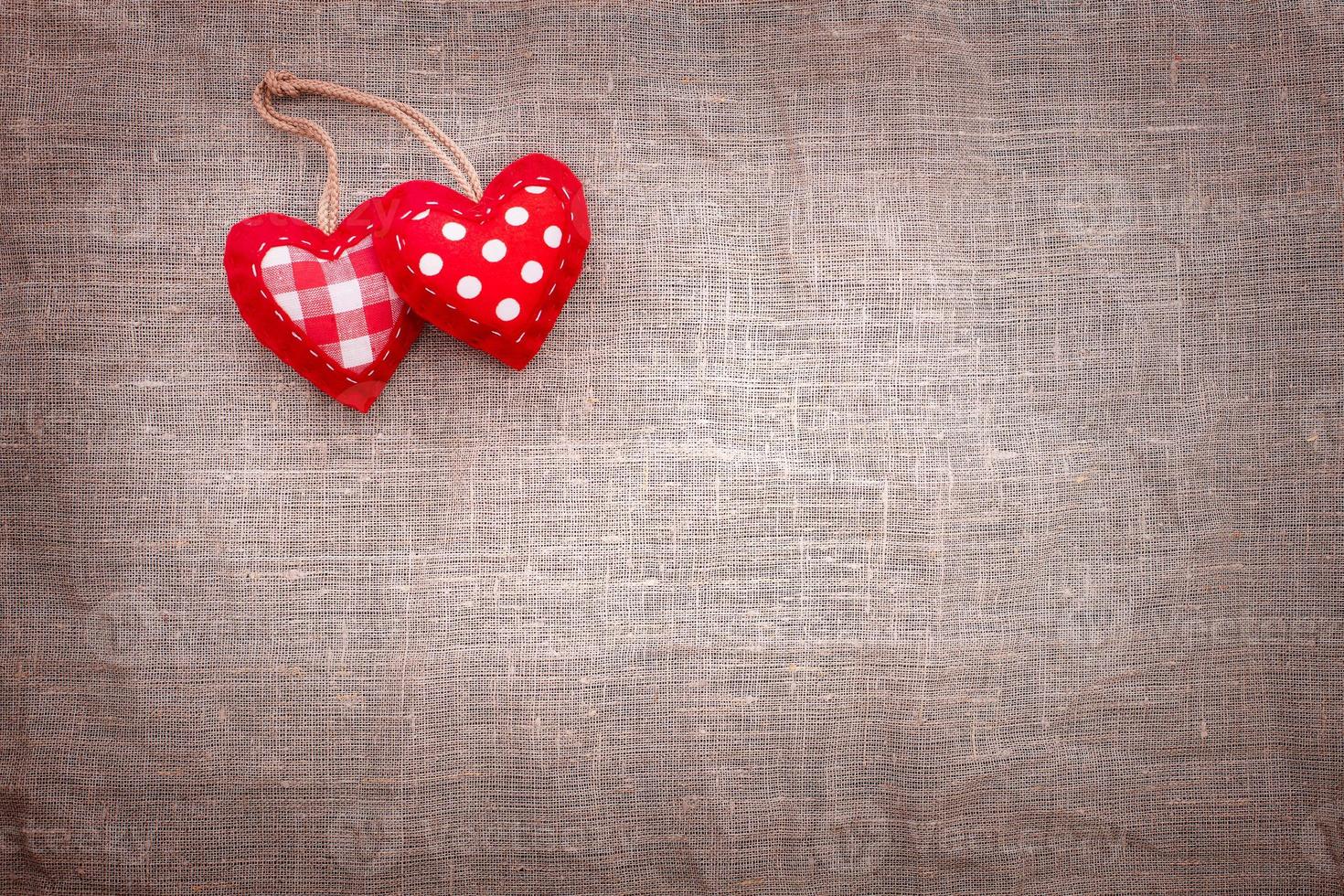 Love hearts on textile texture background. Valentines day card concept. Heart for Valentines Day Background. photo