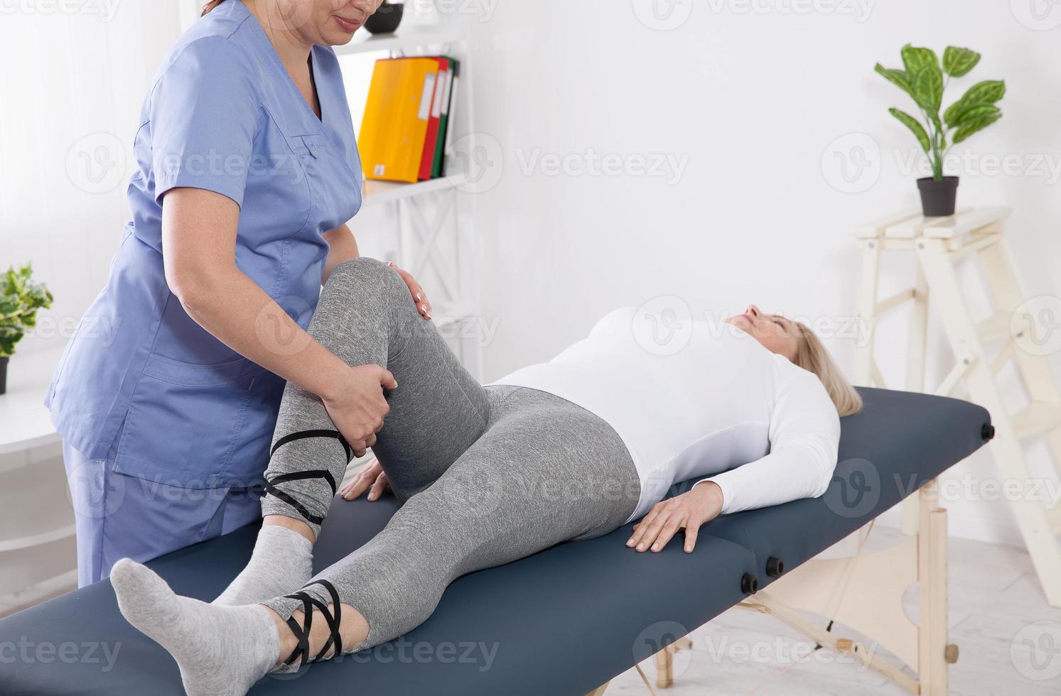 Physiotherapist working with patient in clinic, closeup. Health recovery concept photo