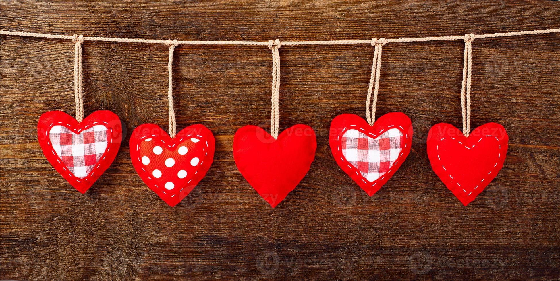 Valentines Vintage Handmade Hearts over Wooden Background. photo