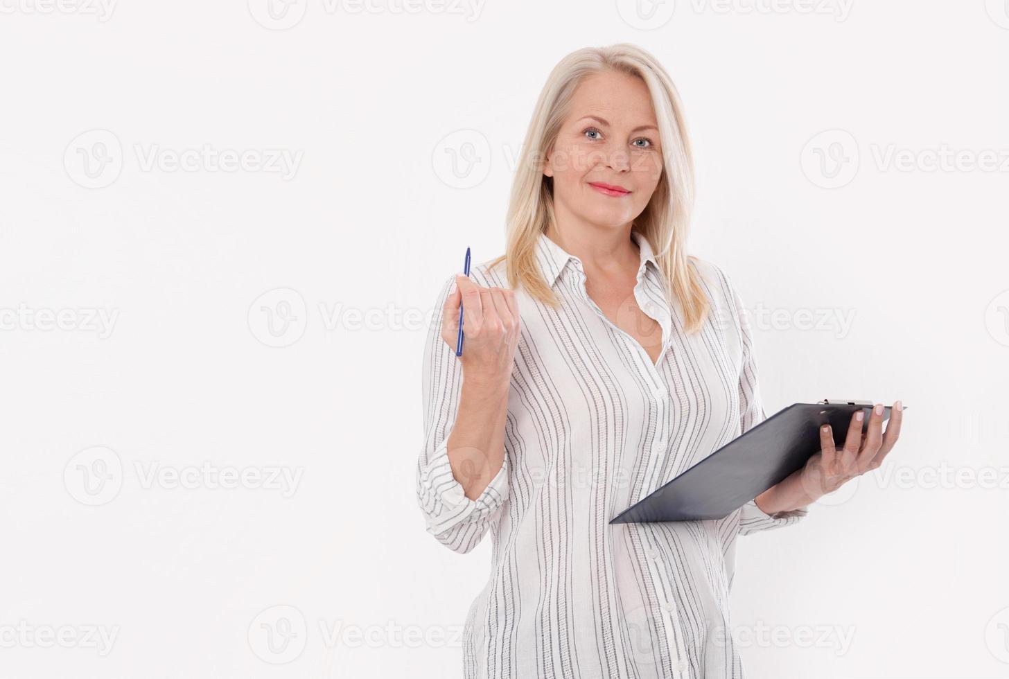 Business woman holds a pen and a folder with files isolated on white background photo