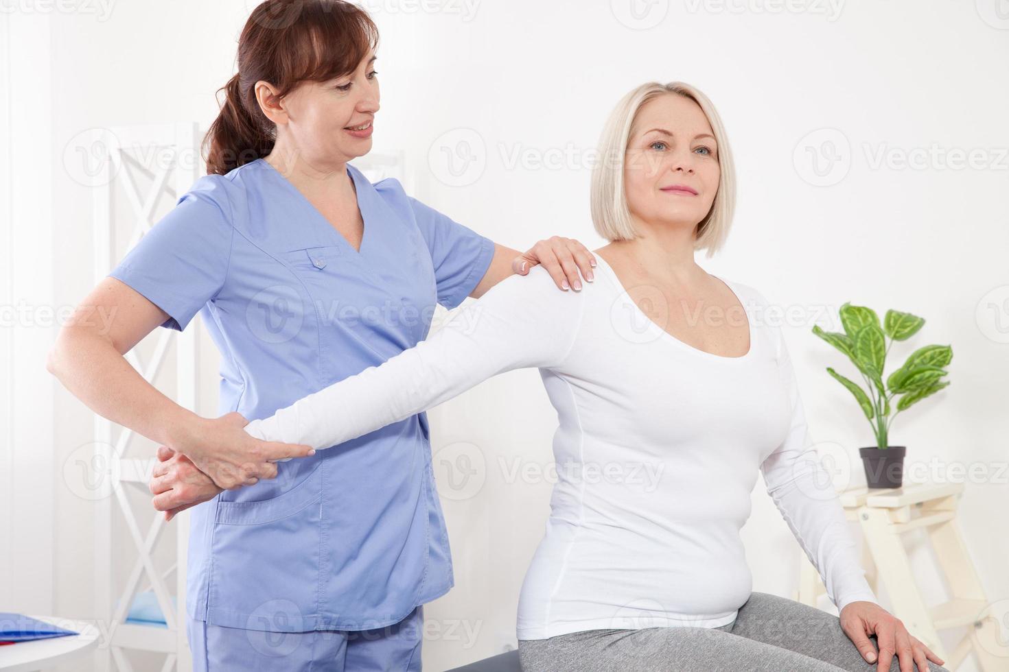 Picture of middle aged woman during rehabilitation in professional clinic photo