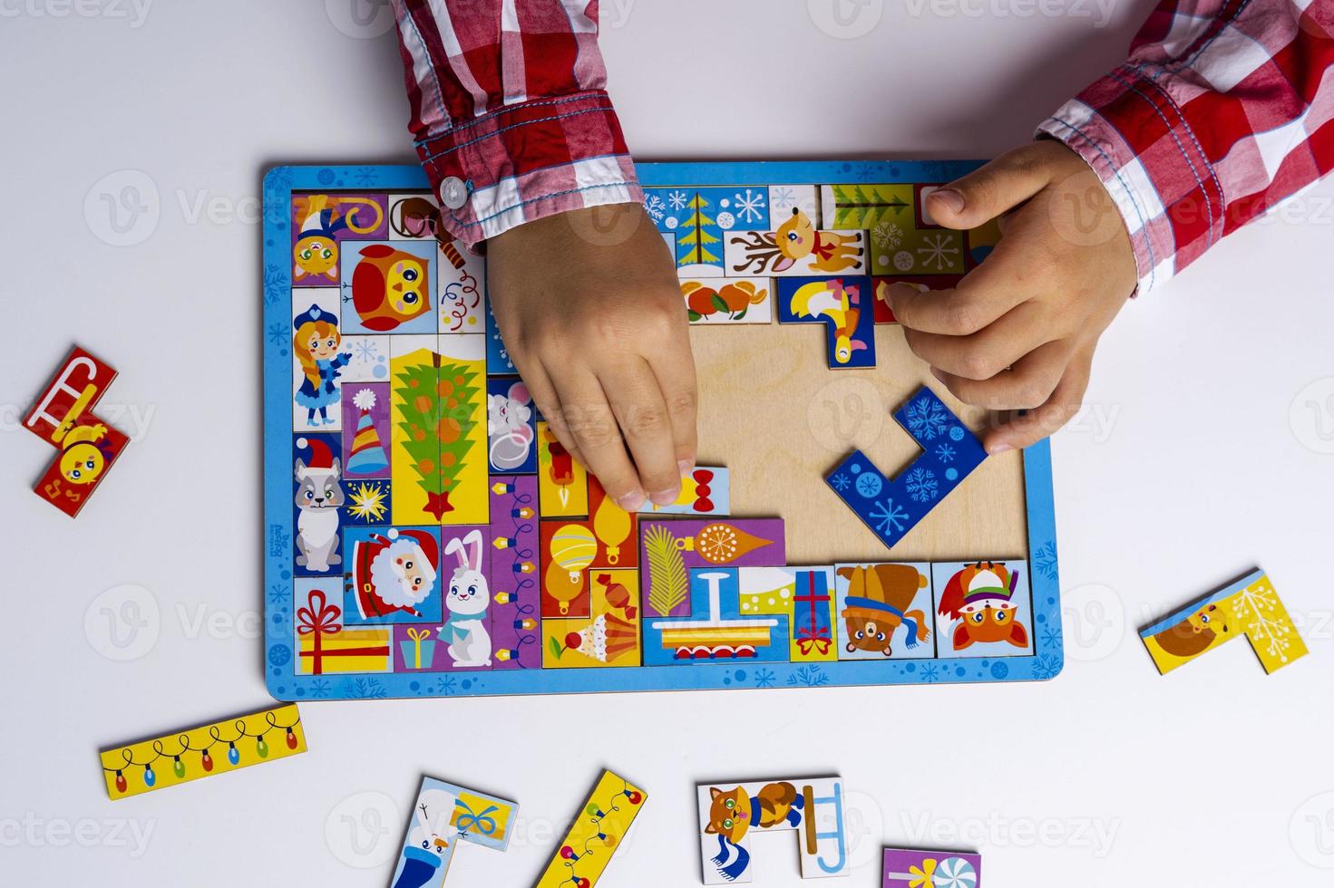 The child collects a puzzle. Puzzle puzzle concept of early development. Children's hands put the puzzle on the table photo