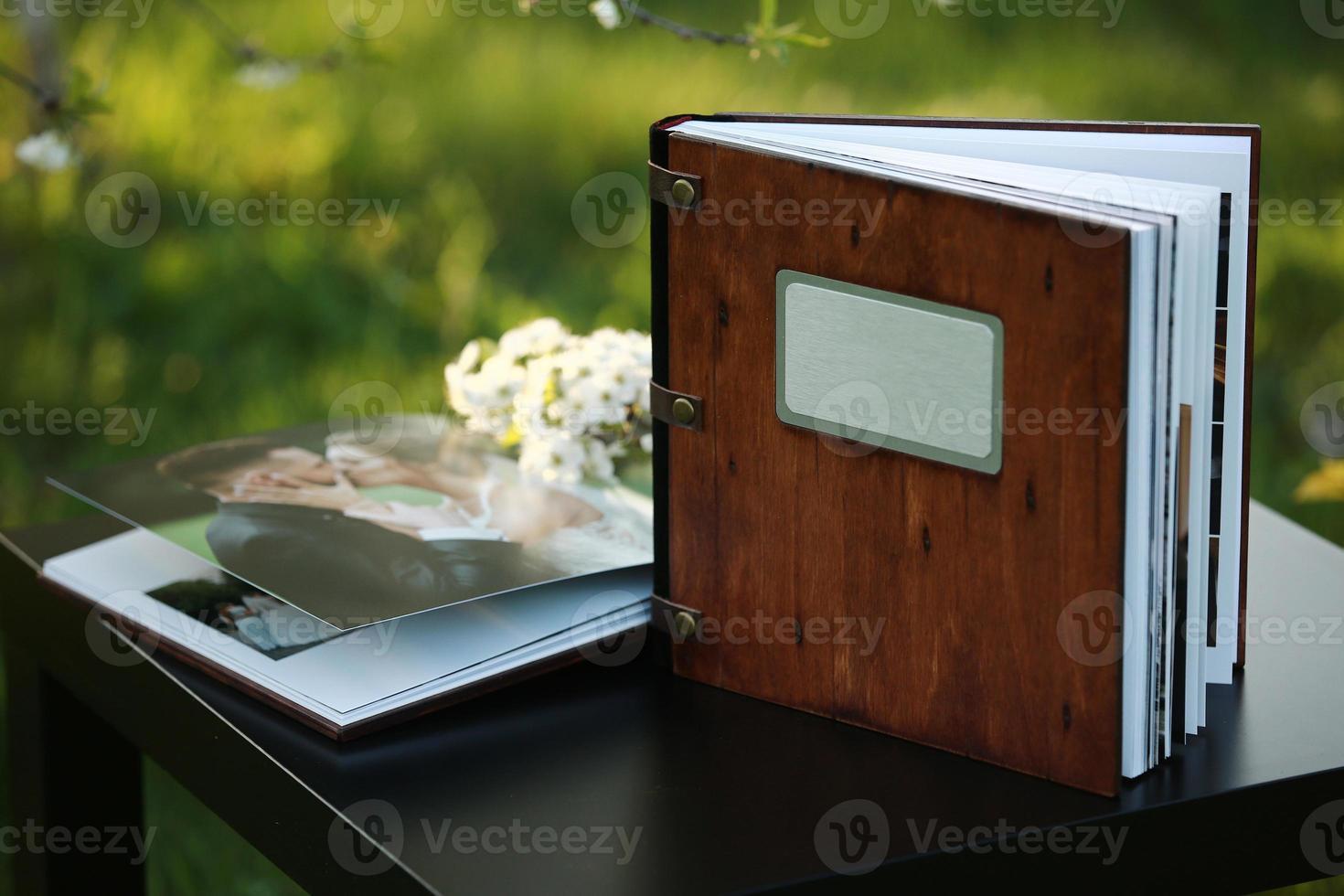 wooden photobook on the table. place for the inscription photo