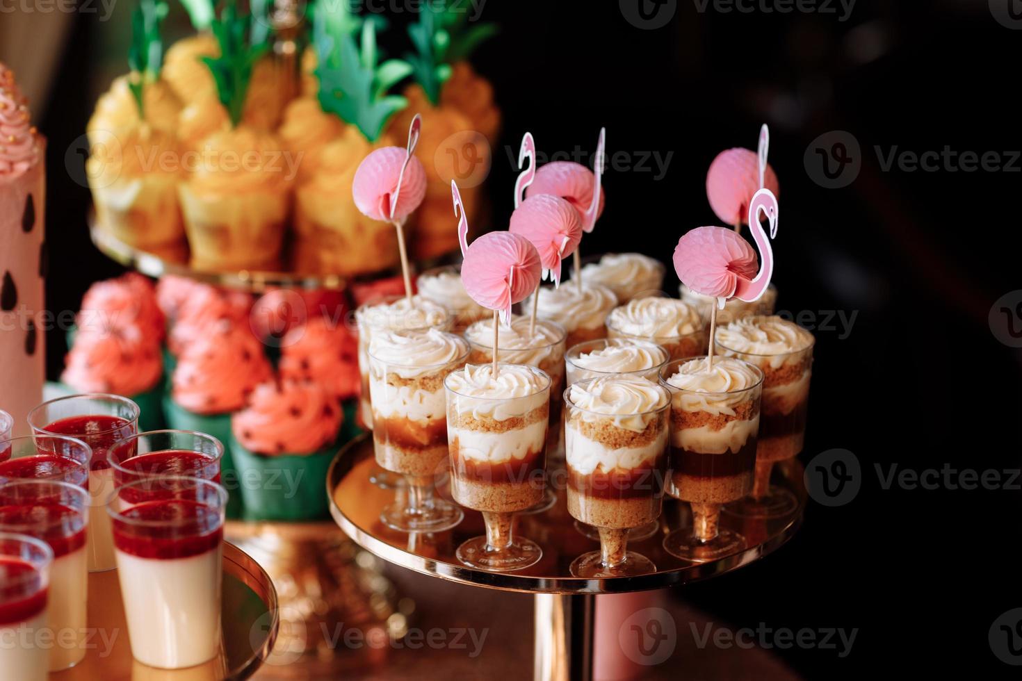 birthday exitic catering, table with modern desserts, cupcakes, sweets with fruits. delicious candy bar at expensive birthday party. space for text. baby shower. holiday celebration photo