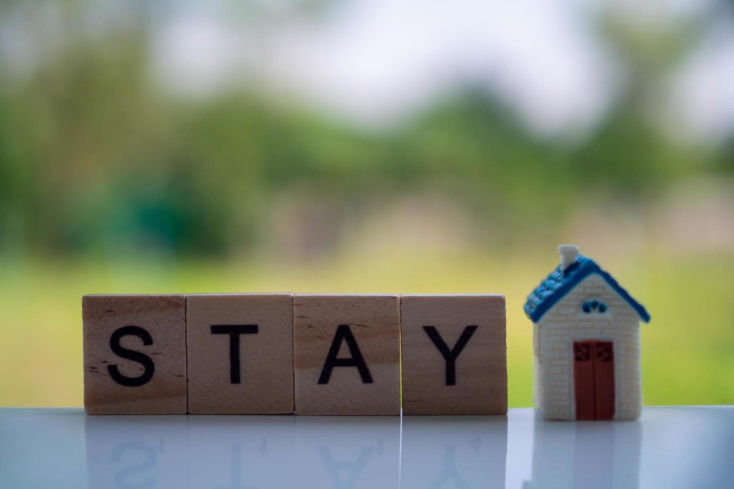 letters on the wooden blocks are arranged in the word STAY to join the campaign so everyone stays at home, not outside. During the spread of the covid19 virus. photo
