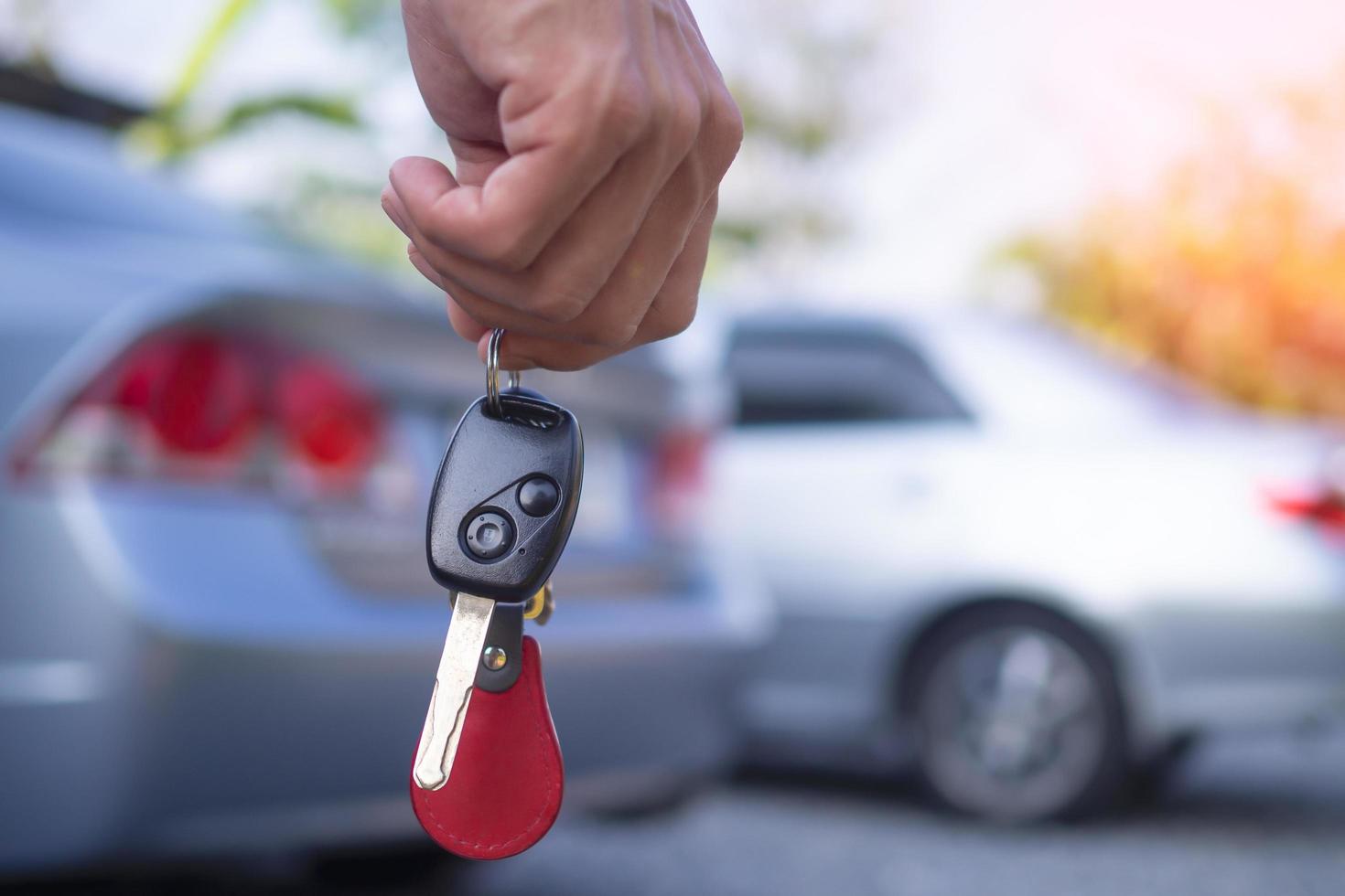 The car salesman and the key to the new owner. photo