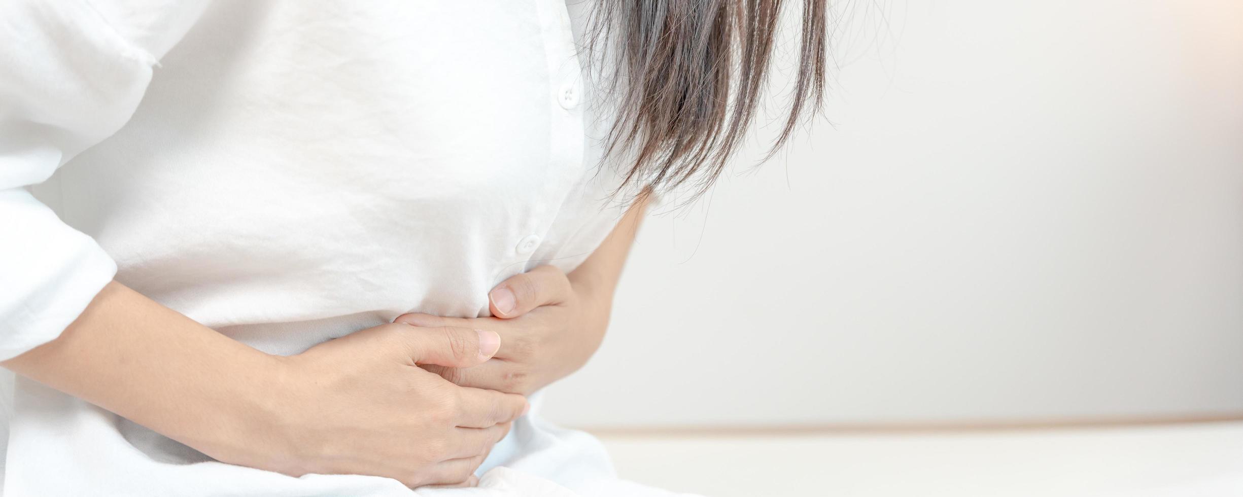 stomach ache. Asian women have abdominal pain, indigestion, gastritis, menstrual cramps, flatulence, diarrhea, distention, colon cancer, belly inflammation problem, suffer food poisoning, abdomen photo