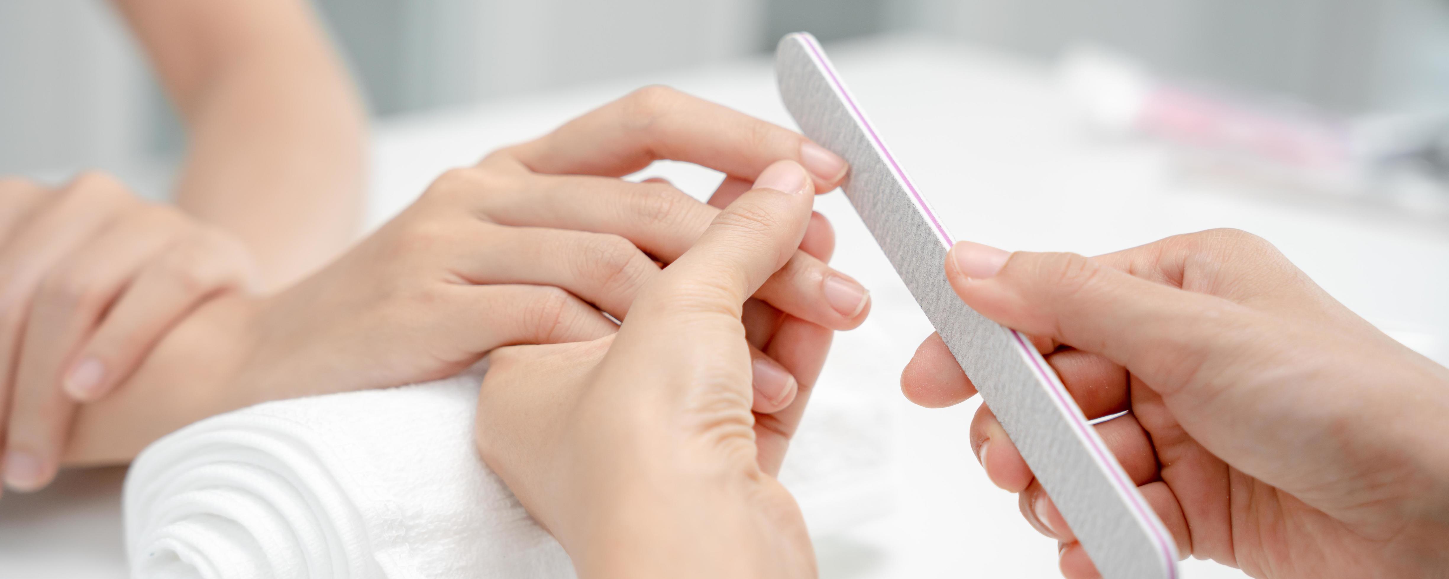 Woman receive care service by professional Beautician Manicure at spa