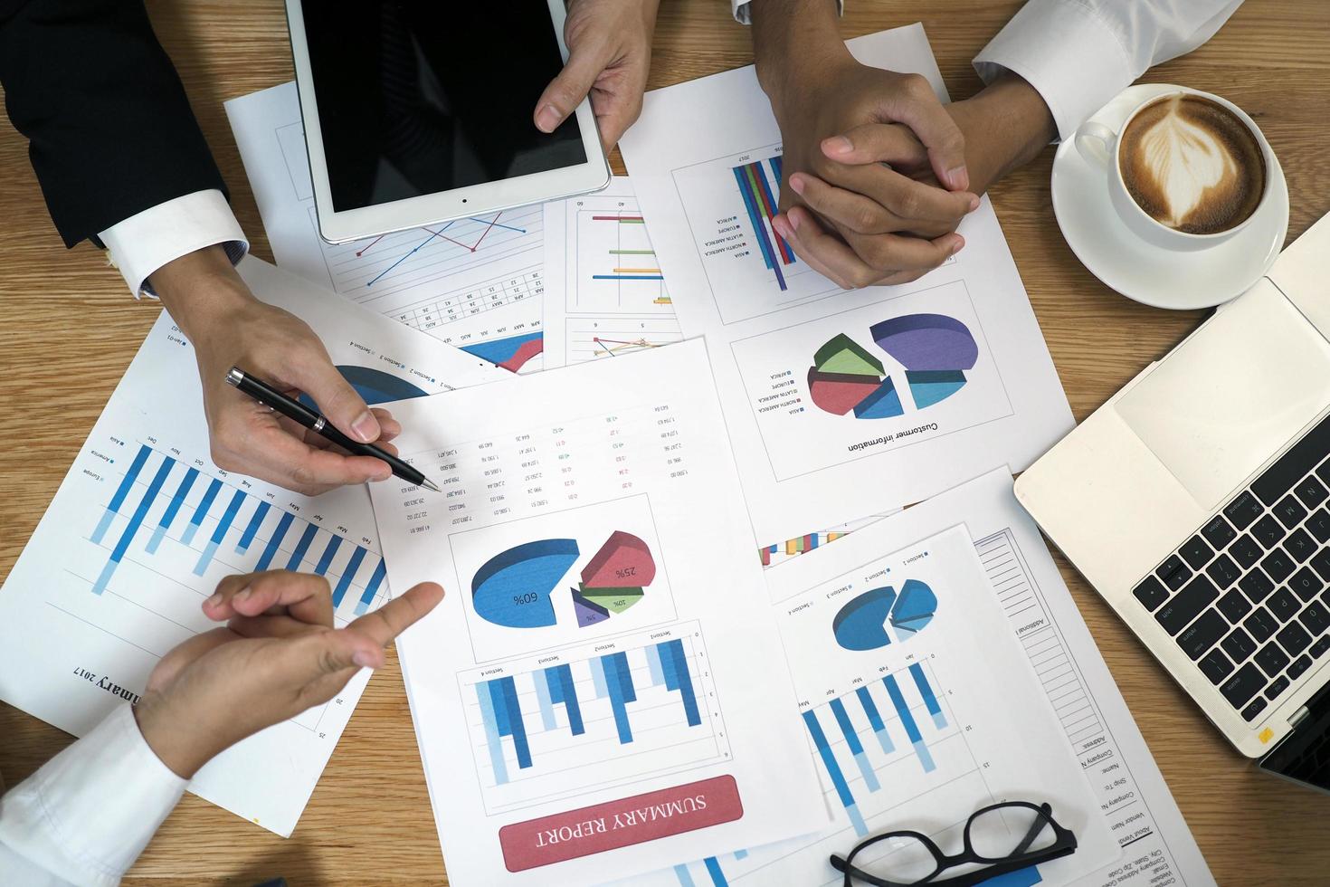 Brainstorming stock market investment plans. With statistical data showing profits and income. teamwork concept photo