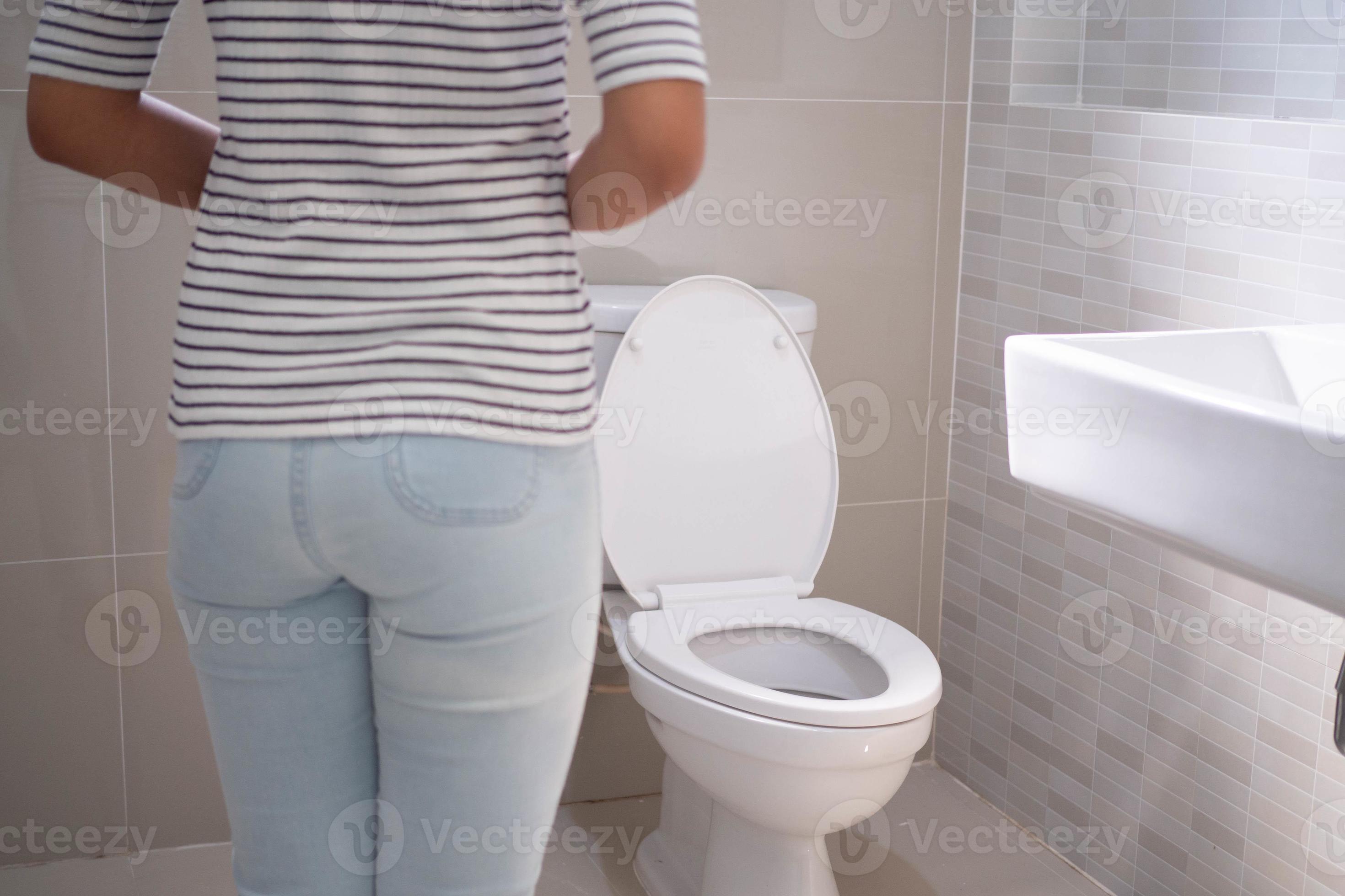 Constipation and diarrhea in bathroom. Hurt woman touch belly stomach