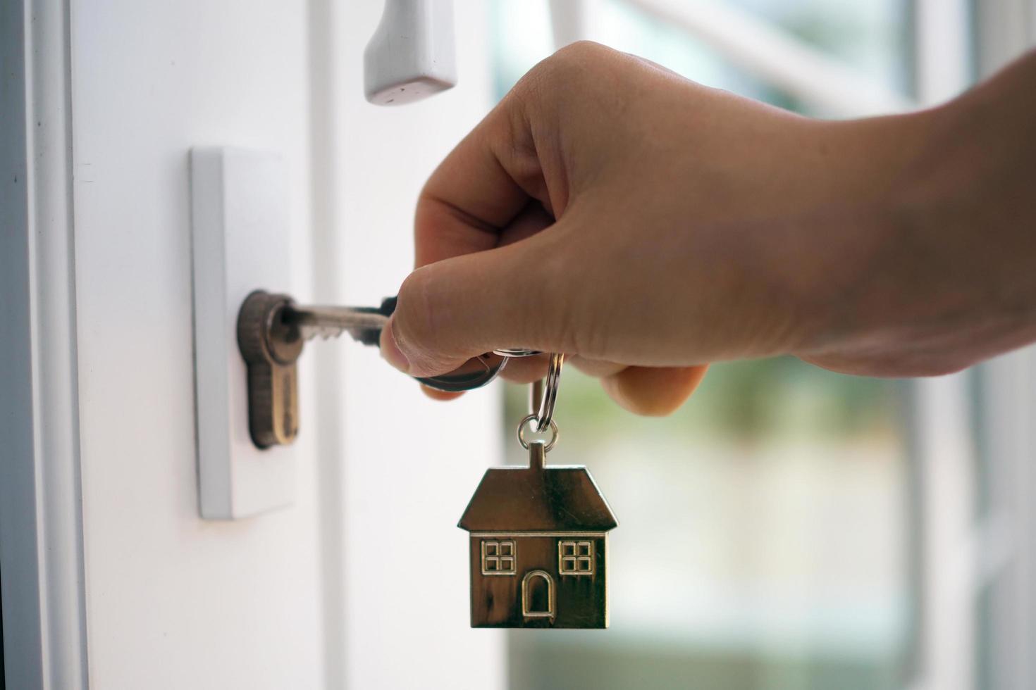 Landlord unlocks the house key for new home photo