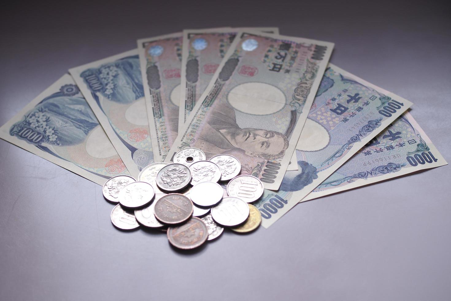 Japanese yen notes and Japanese yen coins for money concept background photo