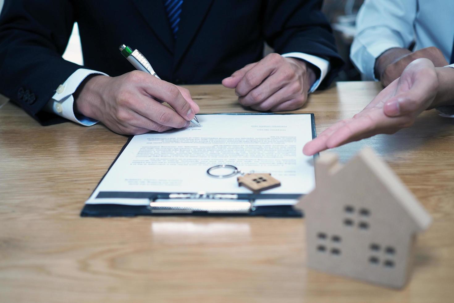 Businessmen sign contracts for investment in construction and housing projects, contract documents that have legal consequences. Buying, selling and renting concept photo