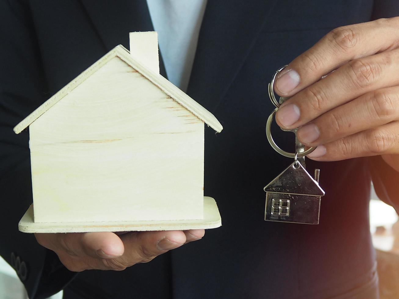 Homeowners are delivering home keys to tenants or buyers. Home sales concept photo