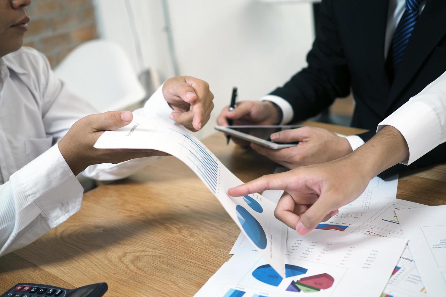 Lluvia de ideas sobre planes de inversión en bolsa. con datos estadísticos que muestran ganancias e ingresos. concepto de trabajo en equipo foto